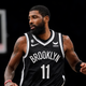 Brooklyn Nets guard Kyrie Irving (11) steps onto the court during the first half of an NBA basketball game against the Dallas Mavericks, Thursday, Oct. 27, 2022, in New York City. (AP Photo/John Minchillo)